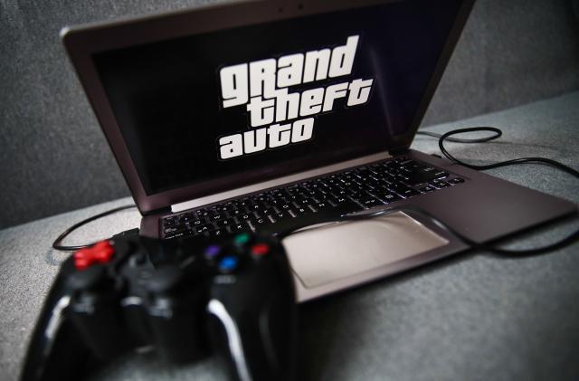Grand Theft Auto logo displayed on a laptop screen and a gamepad are seen in this illustration photo taken in Krakow, Poland on September 21, 2021. (Photo by Jakub Porzycki/NurPhoto via Getty Images)