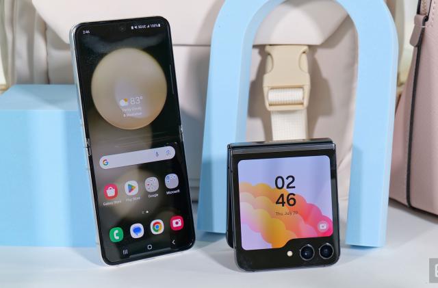 A Galaxy Z Flip 5 leaning against a pastel blue cube with its inside screen facing the camera, next to another Galaxy Z Flip 5 folded in half and propped up with its outside display facing the camera.