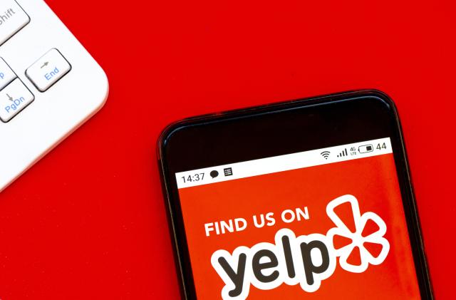 UKRAINE - 2020/04/07: In this photo illustration a Yelp logo seen displayed on a smartphone. (Photo Illustration by Igor Golovniov/SOPA Images/LightRocket via Getty Images)