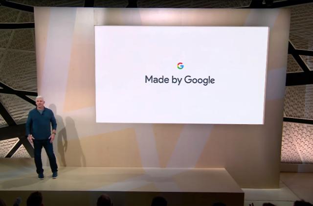 A person standing on a stage in front of a screen that shows the words "Made by Google" below a Google logo.