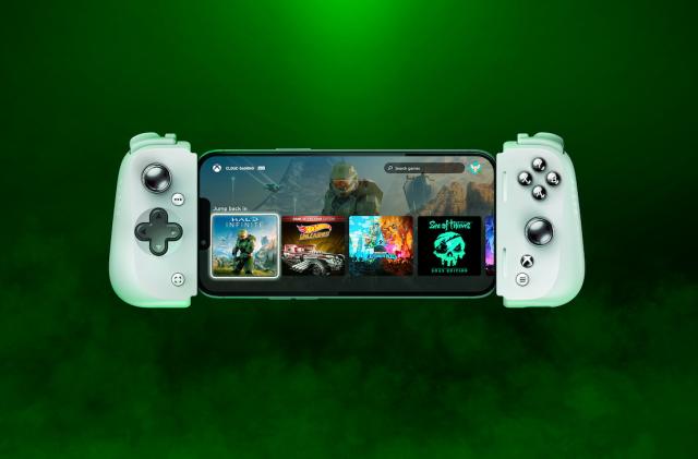 A Razer Kishi mobile controller with a phone in it floats in a green mist with a black background.
