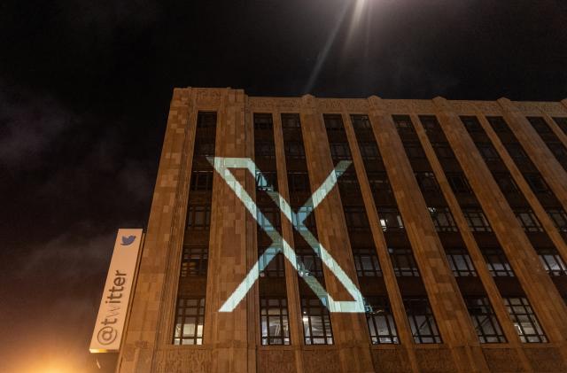 Twitter's new logo is seen projected on the corporate headquarters building in downtown San Francisco, California, U.S. July 23, 2023. REUTERS/Carlos Barria